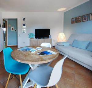 a living room with a table and chairs and a couch at Marine Melody House - Perfect for relaxing getaway in Lajares