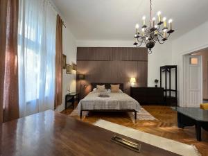 a bedroom with a bed and a chandelier at Hillside Luxury Residence Budapest with free garage in Budapest