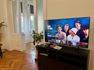 a flat screen tv sitting on a stand in a living room at Hillside Luxury Residence Budapest with free garage in Budapest