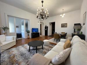 a living room with a couch and a table at Hillside Luxury Residence Budapest with free garage in Budapest