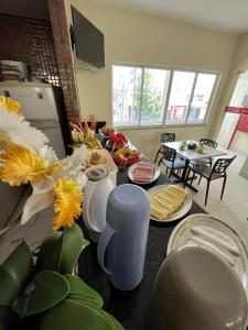 eine Küche mit einem Tisch und Teller mit Lebensmitteln darauf in der Unterkunft SD Plaza Hotel in Sobral