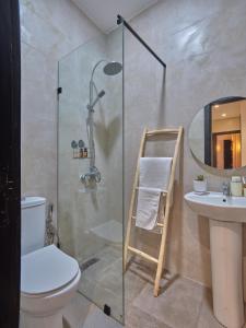 a bathroom with a shower and a toilet and a sink at TheCasaEdition Gauthier Residency City Center in Casablanca