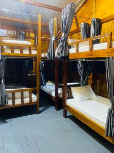 a group of bunk beds in a room at Eco Floating Farm Stay Cai Beo in Cat Ba