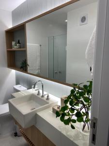 uma casa de banho com um lavatório e um espelho em Lagoa relax no Rio de Janeiro