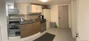 a small kitchen with a sink and a refrigerator at L&L A66 Ferienwohnung in Gründau