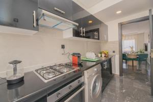 a kitchen with a stove and a sink in it at TheCasaEdition Gauthier Residency City Center in Casablanca