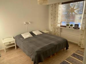 ein Schlafzimmer mit einem großen Bett und einem Fenster in der Unterkunft Row house in Meltosjärvi in Meltosjärvi