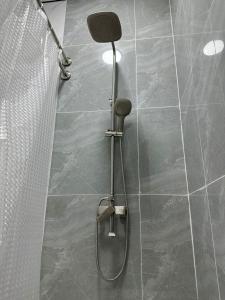a shower with a shower head in a bathroom at мини-отель Villa Sofia город Шымкент, проспект Тауке хана, жилой дом 37-2 этаж in Shymkent