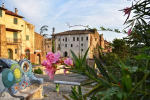 a bench in a courtyard with flowers and buildings at Il Cortile del Castello in Capena