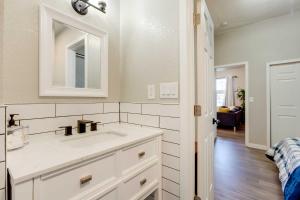 a white bathroom with a sink and a mirror at Updated Denver Home Near Parks, Dining and Shops! in Denver