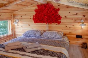 a bedroom with a bed with a large red flower at Loya Bungalov İznik in İznik