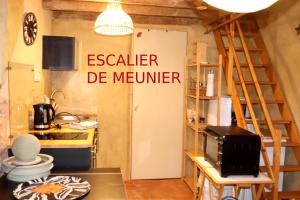 a kitchen with a door with a sign that reads easier de member at Gîtes Les Fleuries in Saint-Méen-le-Grand