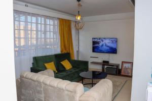a living room with a couch and a table at The Sky House BnB in Nairobi