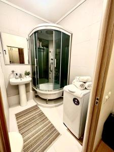 a bathroom with a shower and a toilet and a sink at Orange in Almaty