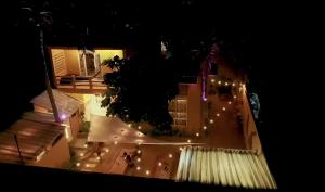 an overhead view of a building with lights at night at La Palmera Hostel in Puerto Escondido