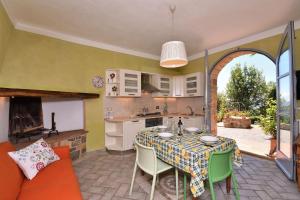 a kitchen and a dining room with a table and chairs at Casanovina in Castellina in Chianti