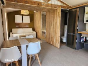 a dining room with a table and white chairs at Petite maison cosy in Hyères +4 photos