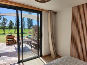 a room with a sliding glass door to a patio at Petite maison cosy in Hyères