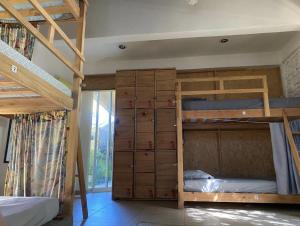 a bedroom with two bunk beds and a closet at La Palmera Hostel in Puerto Escondido