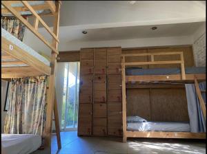 a bedroom with two bunk beds and a staircase at La Palmera Hostel in Puerto Escondido