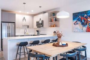 a kitchen with a wooden table and some chairs at Bluebird Daze by Revelstoke Vacations in Revelstoke