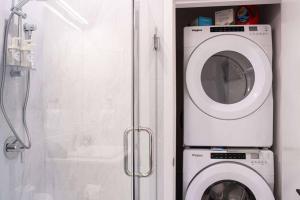 a washing machine in a bathroom next to a shower at Bluebird Daze by Revelstoke Vacations in Revelstoke