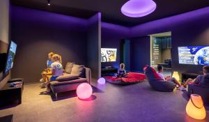 a group of children sitting in a room playing a video game at Valamar Camping Krk in Krk