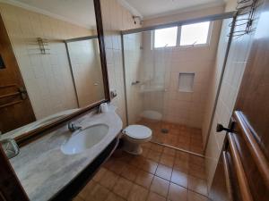 a bathroom with a sink and a toilet and a shower at Marion Pantanal Hotel in Várzea Grande