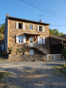 a brick house with a staircase on the side of it at Chez Danièle et Jean-Pierre in Saint-Julien