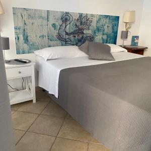 a bedroom with a large bed with a wall at Airport Hotel in Fiumicino