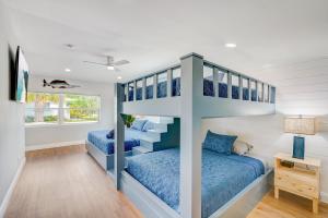 two bunk beds in a boys room with blue beds at Fall Promo! Heated Pool, 6p Golf Cart, Kayak in Clearwater Beach