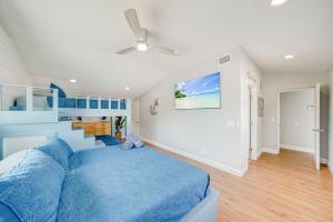 a bedroom with a blue bed and a staircase at Fall Promo! Heated Pool, 6p Golf Cart, Kayak in Clearwater Beach