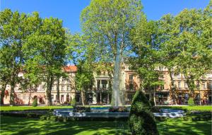 a building with a fountain in the middle of a park at 2 Bedroom Gorgeous Home In Zagreb in Zagreb