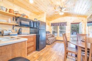 a kitchen and dining room with a table in a cabin at The Shooting Star Cabin #11 at Blue Spruce RV Park & Cabins in Tuckerville