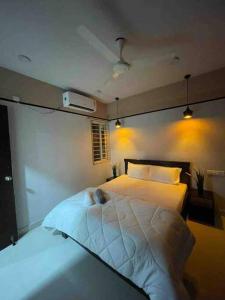 a dog laying on a bed in a bedroom at Apricot: 1bhk Humble Abode in Botanical Gardens in Hyderabad