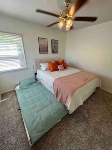 a bedroom with a bed and a ceiling fan at Entire Home by Newport Beach, Disneyland and SNA! in Costa Mesa