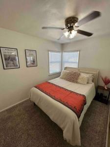a bedroom with a bed with a ceiling fan at Entire Home by Newport Beach, Disneyland and SNA! in Costa Mesa