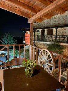 a wooden table with a woodenoked wheel on a patio at Mountain View in Synikia Mesi Trikalon