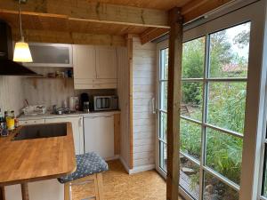 a kitchen with a table and a large window at FeWo im Schwedenstil in Papenburg