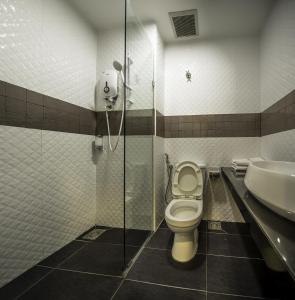 a bathroom with a shower and a toilet and a sink at Crystal Garden Hotel - Seri Kembangan in Seri Kembangan