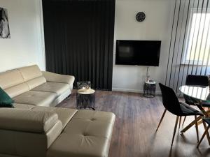 a living room with a couch and a table at Mieszkaj U Marty w GRÓDKU in Jaworzno
