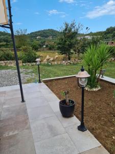 a walkway with two lights and a plant in a pot at La Hacienda in Ulcinj