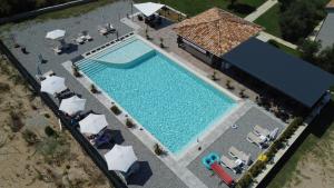 an overhead view of a swimming pool with chairs and a building at La Hacienda in Ulcinj