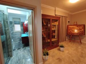 a bathroom with a walk in shower and a glass door at Art Gallery Apartments Tirana in Tirana