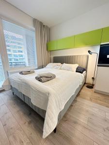 Postel nebo postele na pokoji v ubytování DMR Apartments CityHall