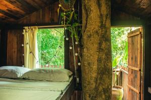 ein Bett in einem Zimmer mit Fenster in der Unterkunft Fazenda Alegria Camping & Aventura in Rio de Janeiro + 38 Fotos