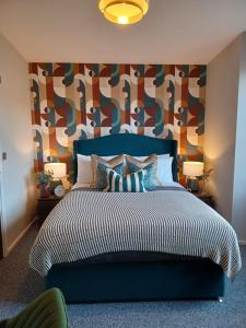 a bedroom with a large bed with a colorful headboard at Stunning Luxury 3 Bed Penthouse Sleeps 2 to 6 in Hythe
