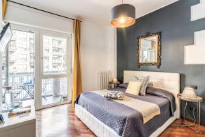 - une chambre avec un lit et une grande fenêtre dans l'établissement Stasera a casa da M.E., à Rome