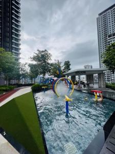 a pool with a water slide in a city at Urban Suites by PerfectSweetHome Cozy Style in Jelutong