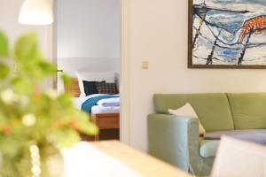 una sala de estar con un sofá y una cama en Fewo Amber Sonne, en Prerow